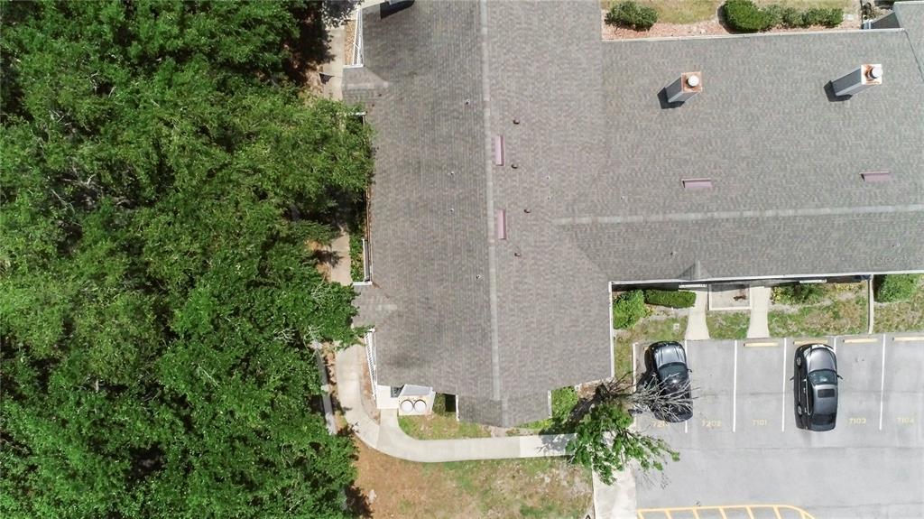 An aerial view shows a multi-unit building roof, adjacent parking spaces, and surrounding trees — 537 SUN RIDGE PLACE UNIT 201, ALTAMONTE SPRINGS, FL