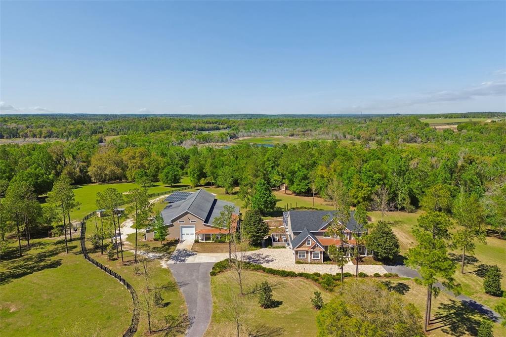 An aerial view shows a house and a large detached garage on a wooded lot — 32641 BLUEBERRY HILL WAY, DADE CITY, FL