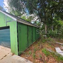 An exterior view of a garage under construction with green ZIP System wall sheathing — 8869 E OGDEN LANE, FLORAL CITY, FL