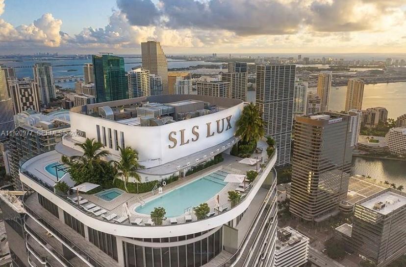 An aerial view of a high-rise rooftop terrace featuring a swimming pool and lounge area — 801 S Miami Ave # 4205, Miami FL 33130, MIAMI, FL