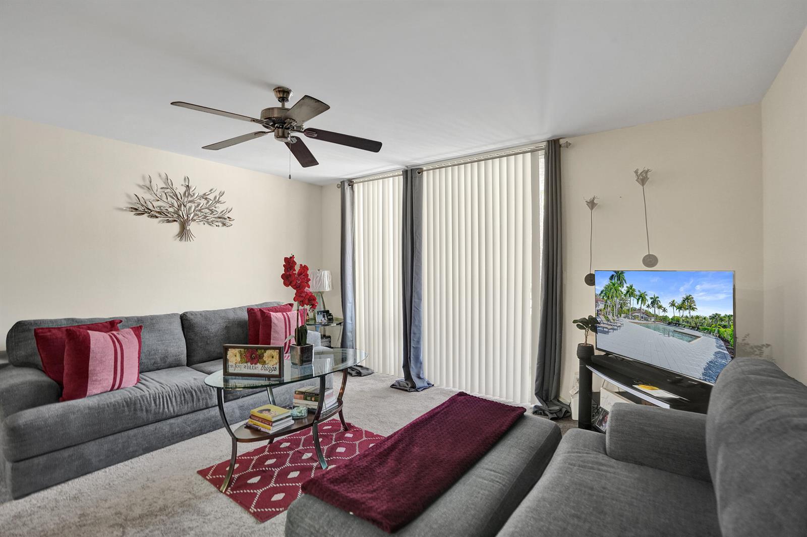 A living room features gray sofas, a glass coffee table, and a ceiling fan — 801 Lyons Road # 19103, Coconut Creek FL 33063, COCONUT CREEK, FL