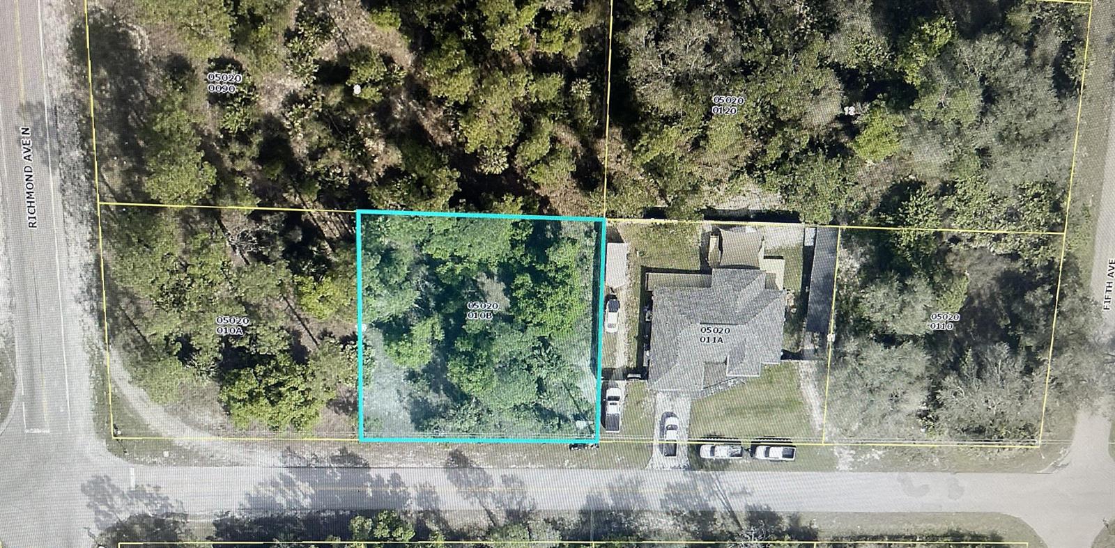 This is an aerial map showing a vacant, wooded lot highlighted in blue next to a house — 403 17th Street E, Lehigh Acres FL 33972, LEHIGH ACRES, FL