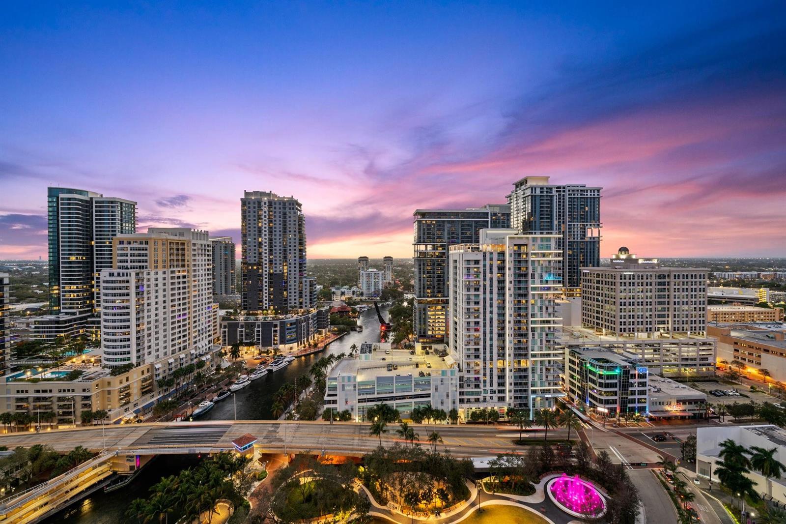 An aerial view of a city skyline with high-rise buildings, a river, and a bridge — 100 E Las Olas Boulevard # 2404, Fort Lauderdale FL 33301, FORT LAUDERDALE, FL