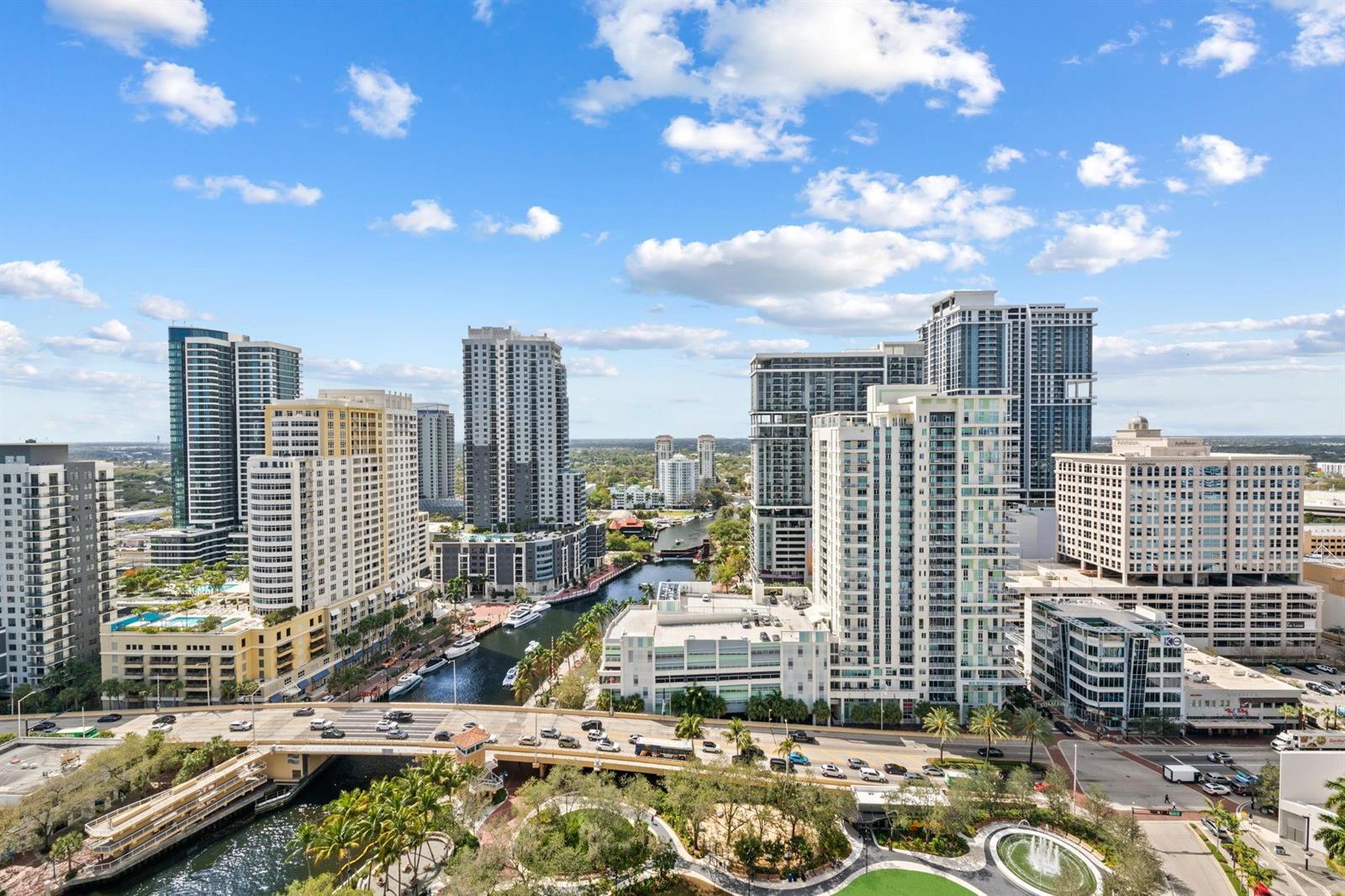 An elevated view of a city skyline featuring high-rise buildings, a canal, and a bridge — 100 E Las Olas Boulevard # 2404, Fort Lauderdale FL 33301, FORT LAUDERDALE, FL
