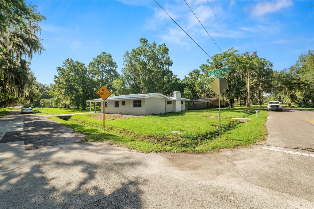 A single-story house sits on a corner lot with a no outlet sign nearby — 1112 N PENNSYLVANIA AVENUE, PLANT CITY, FL
