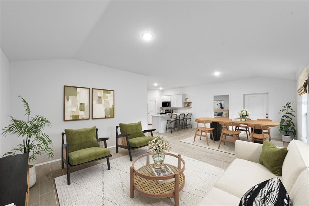 An open-concept living and dining area features light wood-look tile flooring and modern furniture — 343 SHERBOURNE STREET, PORT CHARLOTTE, FL