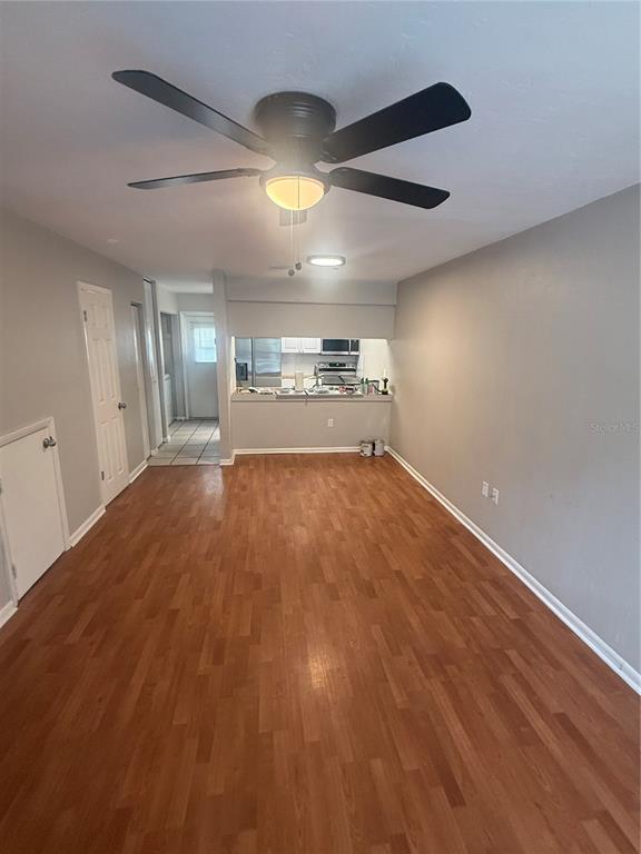 A kitchen features stainless steel appliances, white cabinets, and a black granite countertop — 4017 SW 22ND ROAD UNIT B, GAINESVILLE, FL