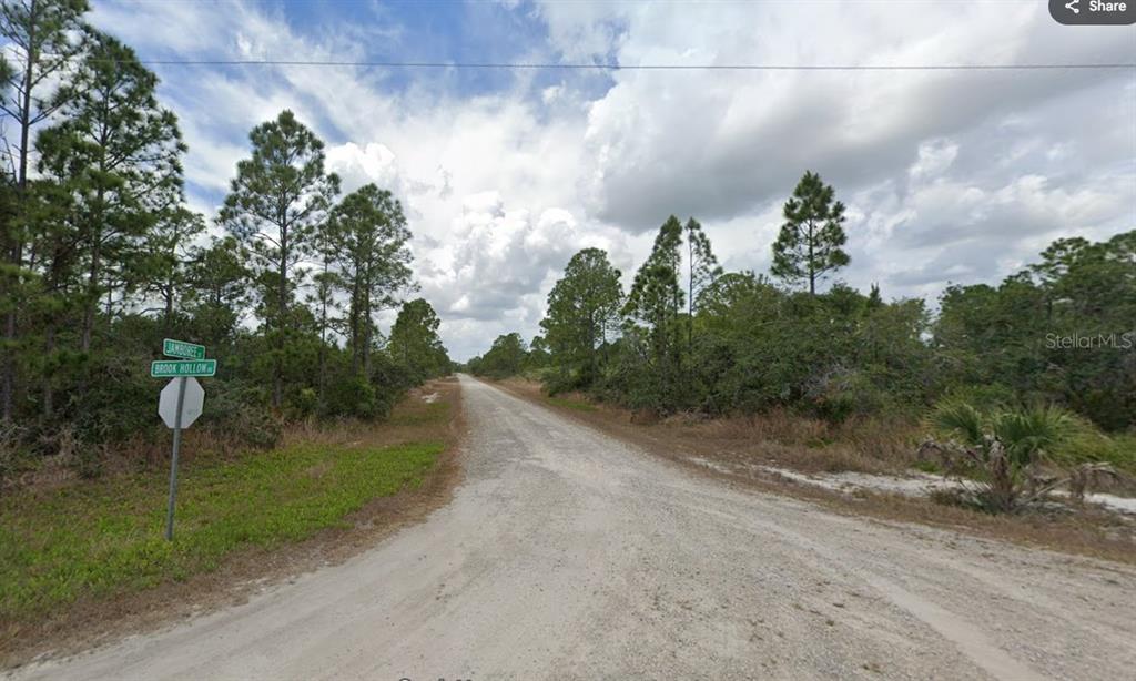 A dirt road intersects at a corner marked by street signs in a wooded area — 3507 & 3509 JAMBOREE STREET, LAKE PLACID, FL