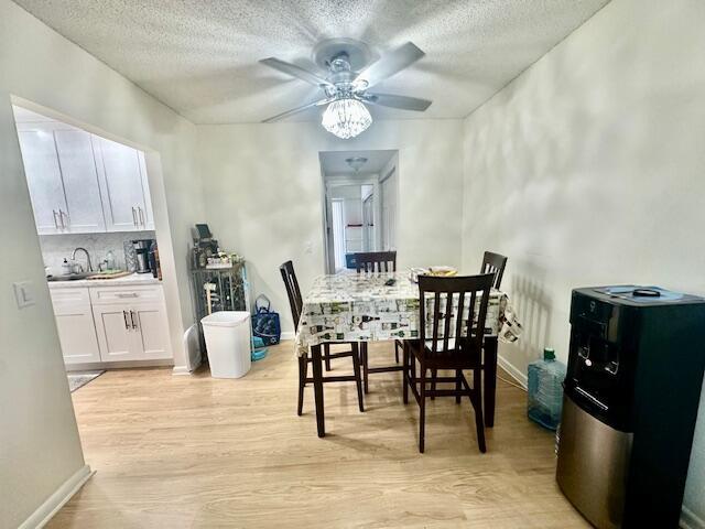 A dining area with a ceiling fan, table, chairs, and a view into the kitchen — 583 Fanshaw, Boca Raton FL 33434, BOCA RATON, FL