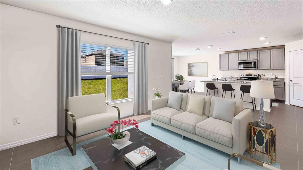 This is a digital rendering of an open-concept living room and kitchen with tile flooring — 10479 TUCKER ROAD, WEEKI WACHEE, FL