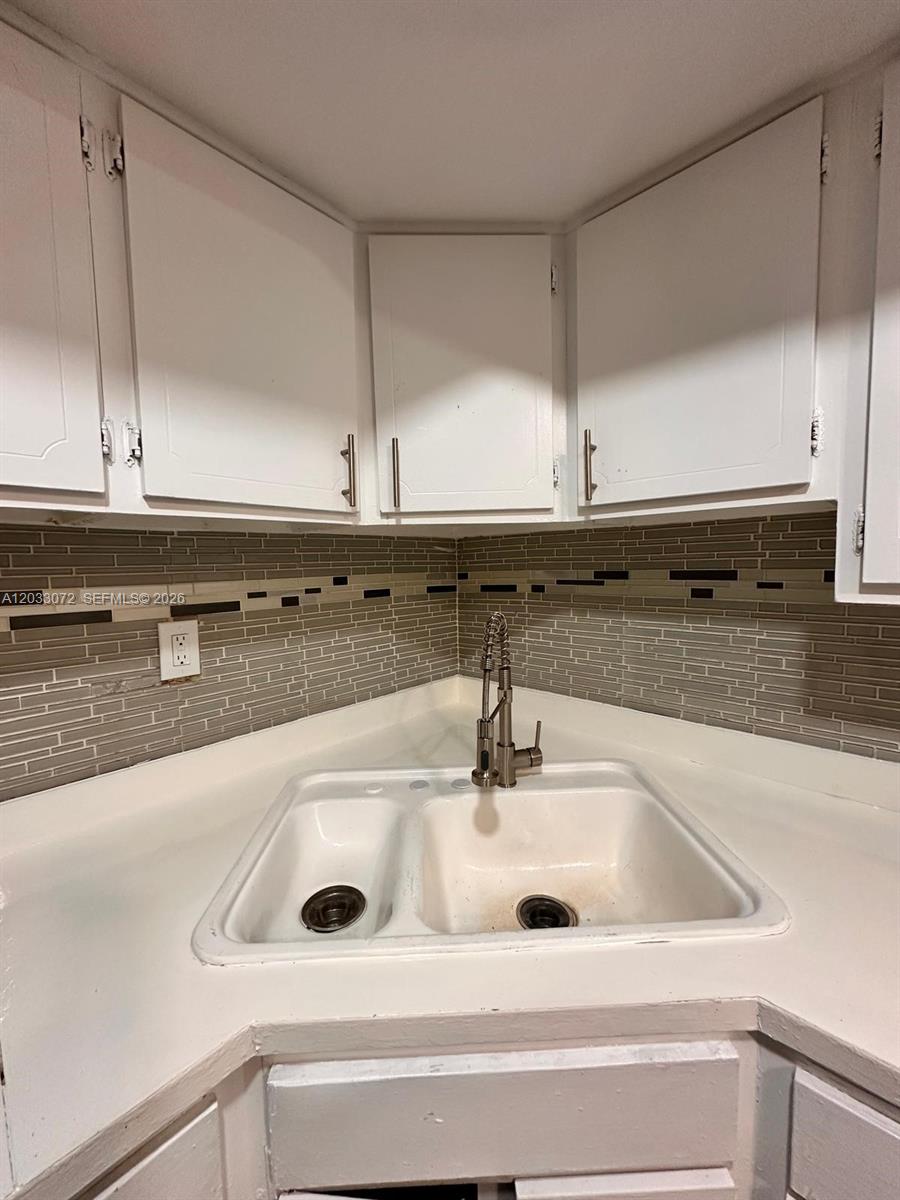 A kitchen corner features a white double-basin sink, a faucet, and a tiled backsplash — 5540 SW 38th Ct # 0, West Park FL 33023, WEST PARK, FL
