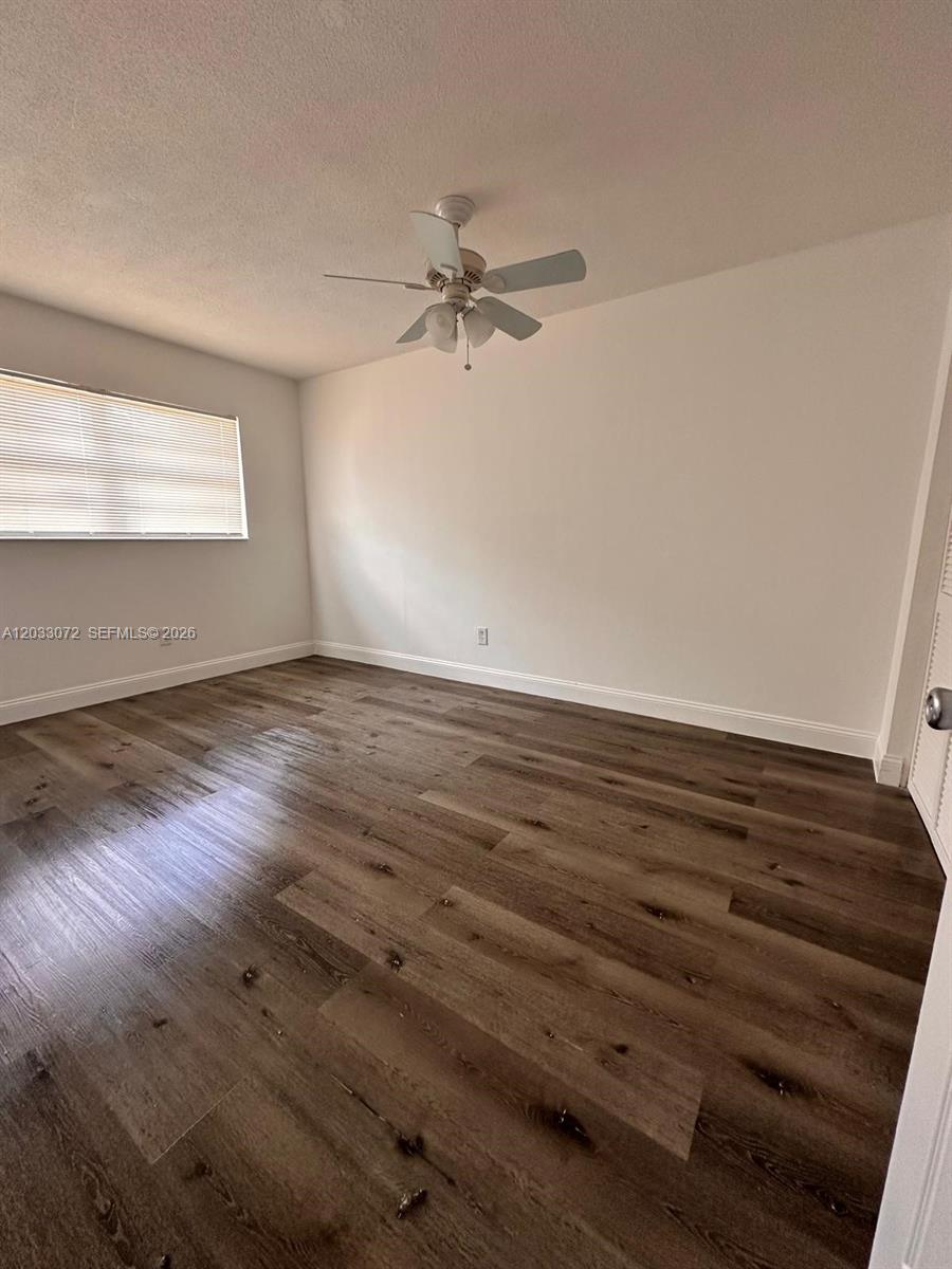 An empty bedroom features wood-look flooring, white walls, and a ceiling fan — 5540 SW 38th Ct # 0, West Park FL 33023, WEST PARK, FL