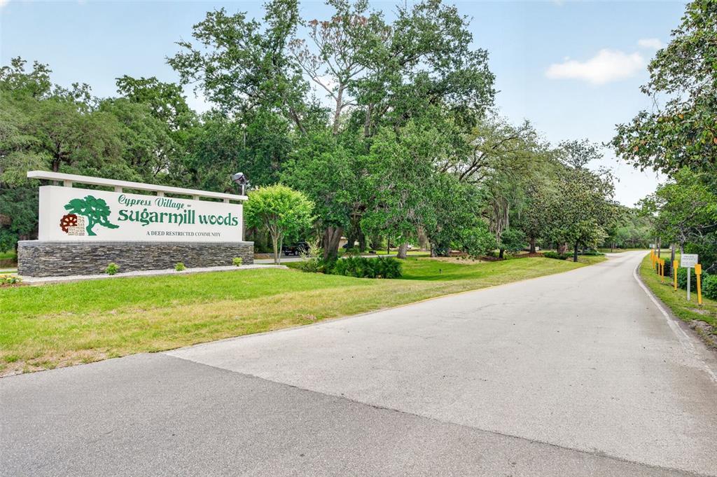 A stone and white sign marks the entrance to the Cypress Village Sugarmill Woods community — 16 GOLFVIEW COURT, HOMOSASSA, FL