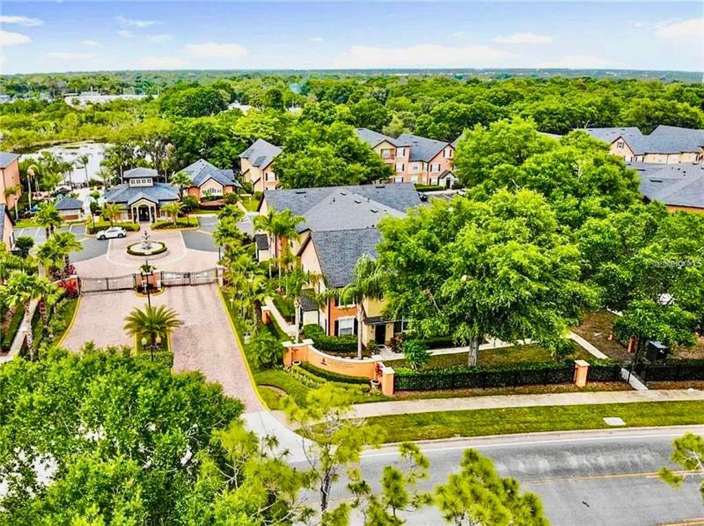 An aerial view shows a gated residential complex with multi-story buildings, lush trees, and landscaping — 6071 Westgate Dr WESTGATE DR UNIT 321, ORLANDO, FL