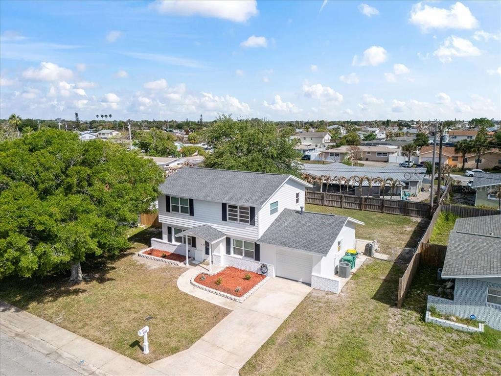 An aerial view of a two-story white house with a gray roof and front yard — 480 SABAL AVENUE, MERRITT ISLAND, FL