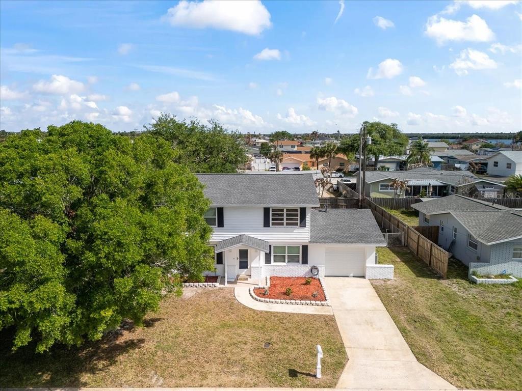 An aerial view of a two-story white house with a gray roof and attached garage — 480 SABAL AVENUE, MERRITT ISLAND, FL