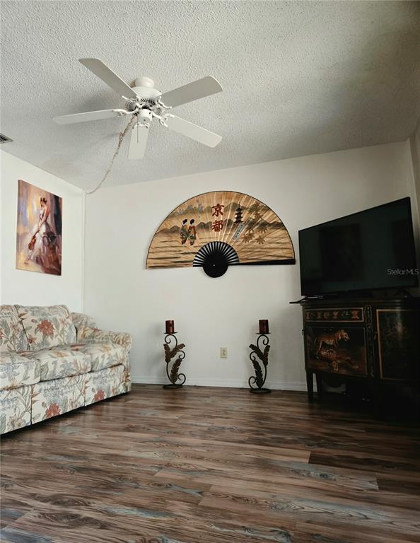A dining room features a glass-top table, six chairs, a ceiling fan, and wall art — 6224 PRINCIPIA DRIVE UNIT 4, FORT MYERS, FL