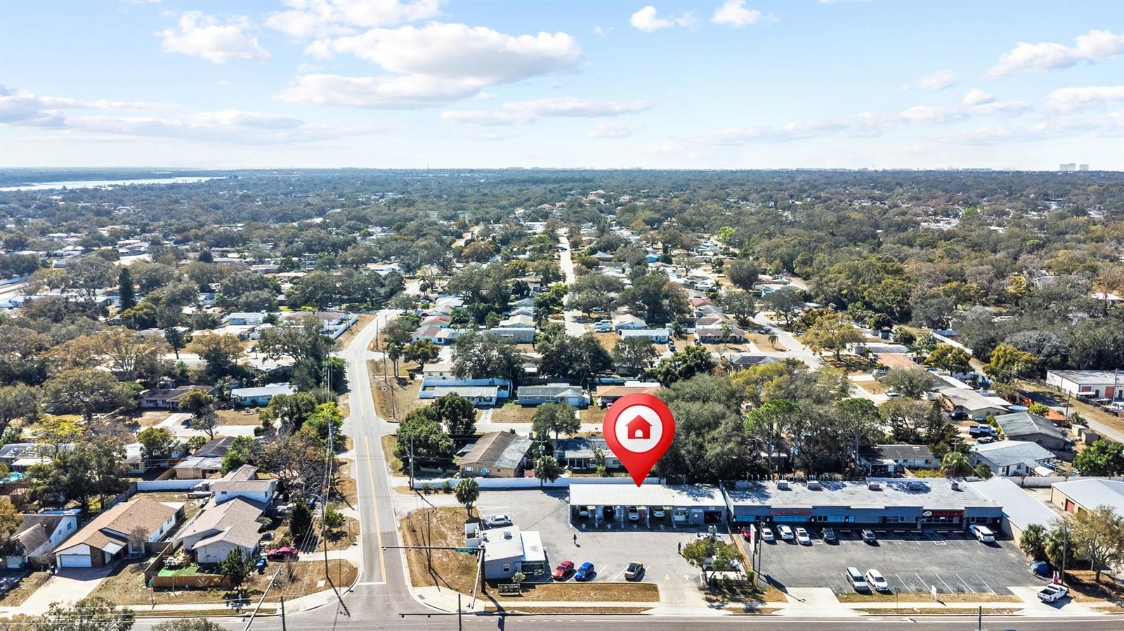 An aerial view shows a commercial strip mall with a parking lot and surrounding residential neighborhood — 11500 Walsingham Road, Largo FL 33778, LARGO, FL