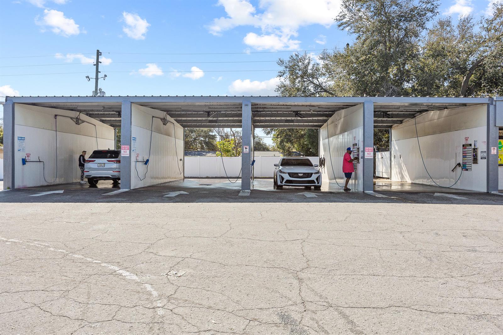 A multi-bay outdoor car wash facility with two vehicles parked under a metal canopy — 11500 Walsingham Road, Largo FL 33778, LARGO, FL
