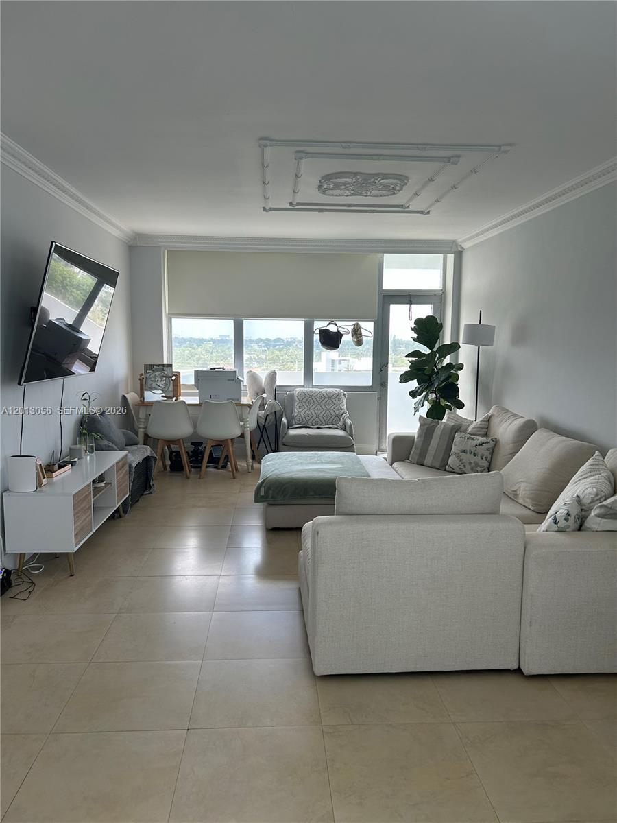 A living room features light tile flooring, a sectional sofa, and a dining area — 7441 Wayne Ave # 7J, Miami Beach FL 33141, MIAMI BEACH, FL