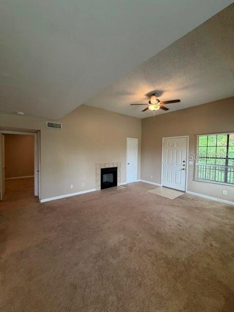 A living room features beige carpet, a fireplace, a ceiling fan, and a front door — 485 FORESTWAY CIRCLE UNIT 205, ALTAMONTE SPRINGS, FL