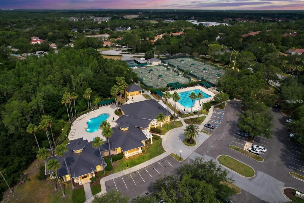 An aerial view of a community clubhouse featuring swimming pools, tennis courts, and parking lots — 10144 ARBOR RUN DRIVE UNIT 31, TAMPA, FL