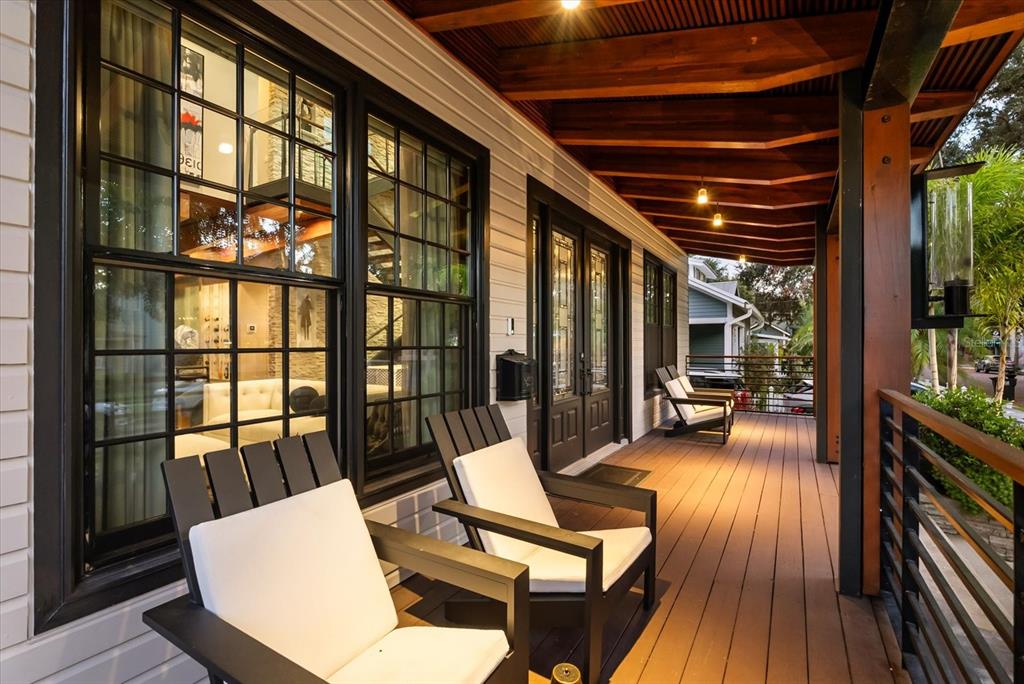 A modern two-story house with light siding, a front porch, and a wooden fence — 119 N HYER AVENUE, ORLANDO, FL