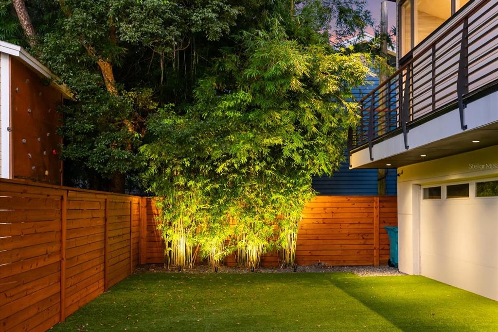 A front porch features a dark double door, wood columns, and two black chairs — 119 N HYER AVENUE, ORLANDO, FL