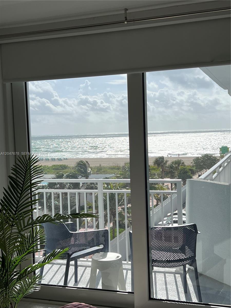 A view of the ocean and beach from a balcony with two chairs — 345 Ocean Dr # 525, Miami Beach FL 33139, MIAMI BEACH, FL