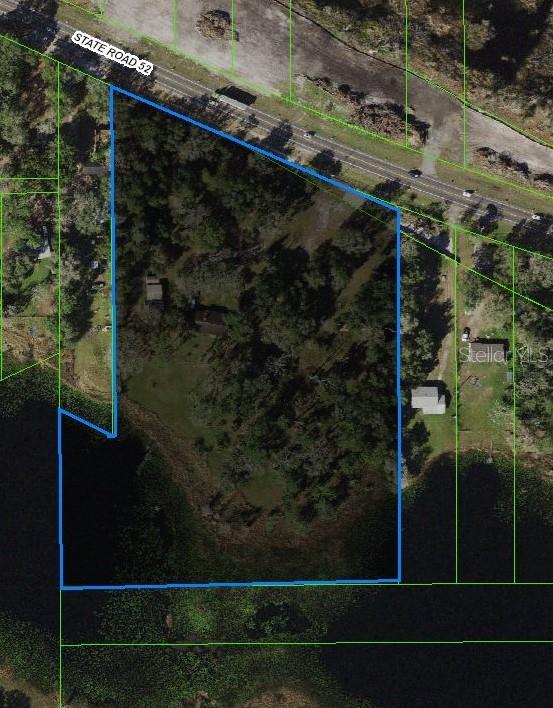 An aerial map shows a wooded, waterfront lot outlined in blue along State Road 52 — 18300 STATE ROAD 52, LAND O LAKES, FL