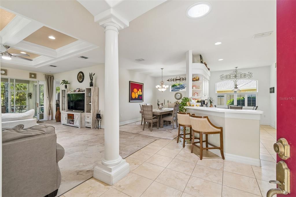 A view from an entryway into an open-concept living and dining area with tile floors — 5212 ESPLANDE COURT, BROOKSVILLE, FL