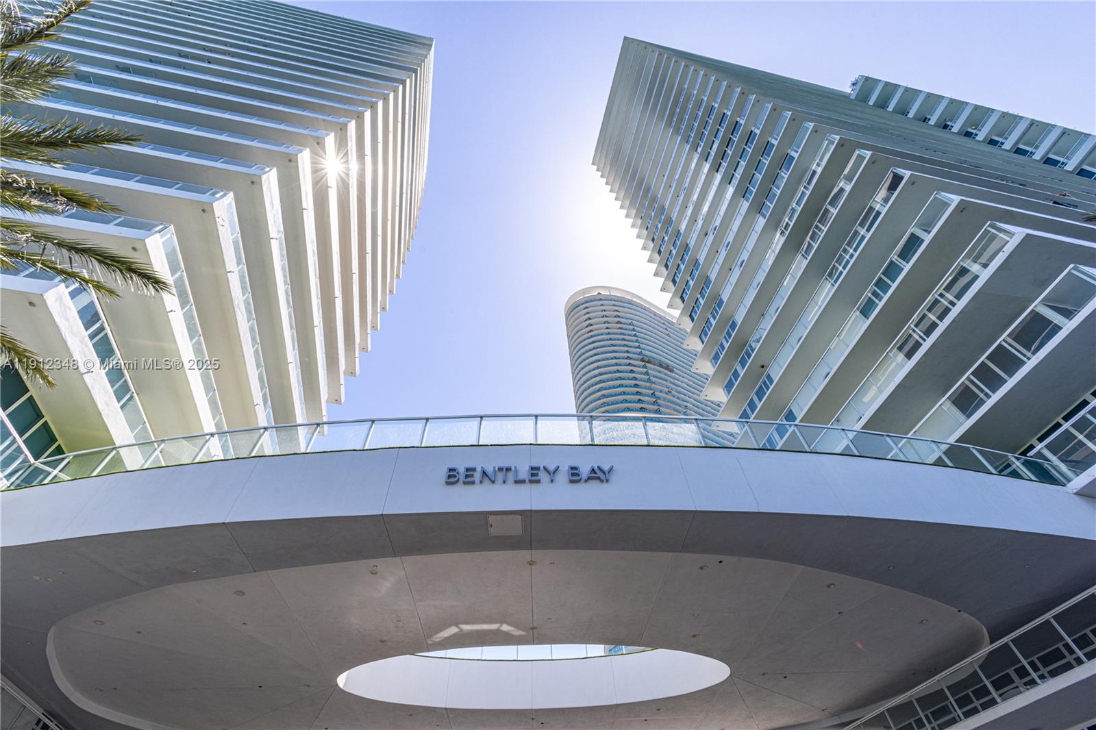 A low-angle view shows the exterior of the Bentley Bay residential towers in Miami — 520 West Ave # 1102, Miami Beach FL 33139, MIAMI BEACH, FL