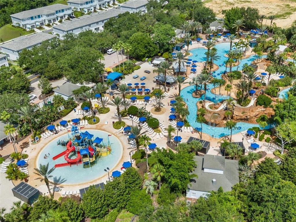 An aerial view shows a resort-style swimming pool complex with water slides and lounge chairs — 7958 HAVERHILL WAY, KISSIMMEE, FL