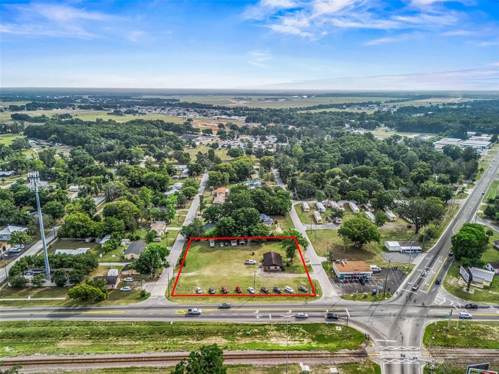 An aerial view shows a rectangular lot with a house, outlined in red, near a road — 6137 SE HAMES ROAD, BELLEVIEW, FL