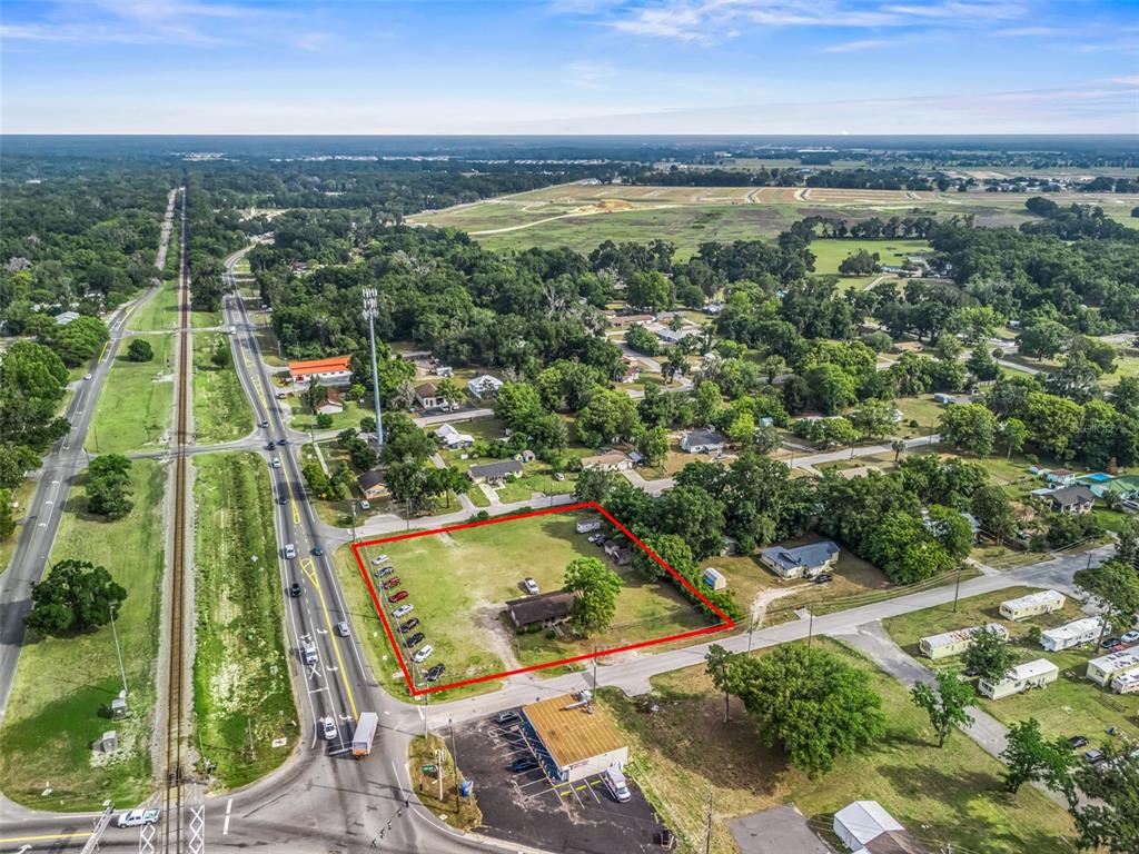 An aerial view shows a rectangular lot outlined in red containing a single-story house — 6137 SE HAMES ROAD, BELLEVIEW, FL