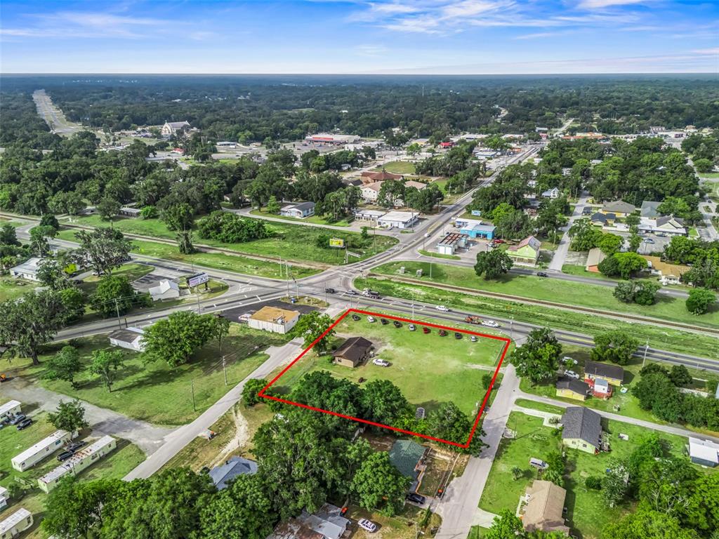An aerial view shows a house on a large lot outlined in red near roads — 6137 SE HAMES ROAD, BELLEVIEW, FL