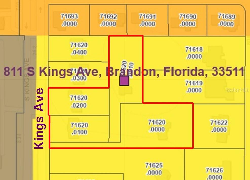 A single-story house with a light-colored exterior sits behind a large lawn and road — 807 S KINGS AVENUE, BRANDON, FL