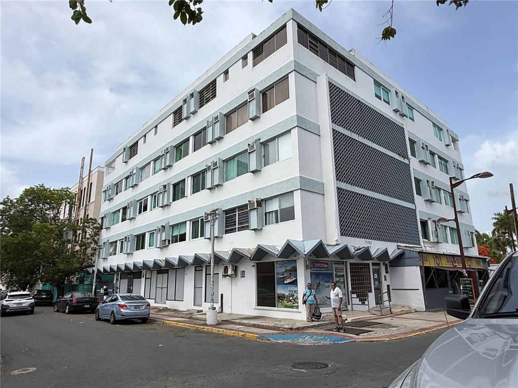 A multi-story white building with a patterned facade stands on a street corner — . BLASCOCHEA UNIT 311, CAROLINA, PR