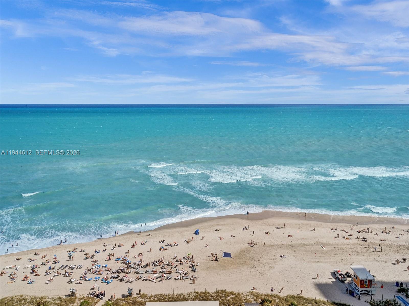 An elevated view of a sandy beach with people and a lifeguard station — 4111 S Ocean Dr # 1201, Hollywood FL 33019, HOLLYWOOD, FL
