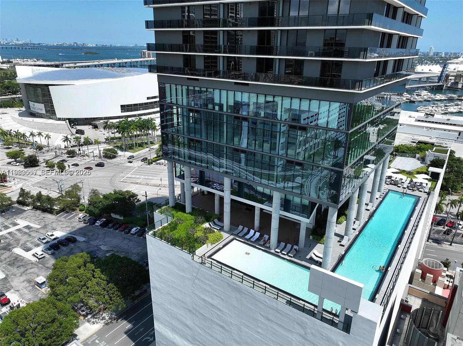 An aerial view shows a high-rise building with a rooftop pool deck and terrace — 398 NE 5th St # 3516, Miami FL 33132, MIAMI, FL