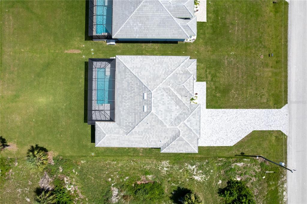 A rectangular swimming pool is enclosed by a screened lanai with paver decking — 221 ROTONDA BOULEVARD S, ROTONDA WEST, FL