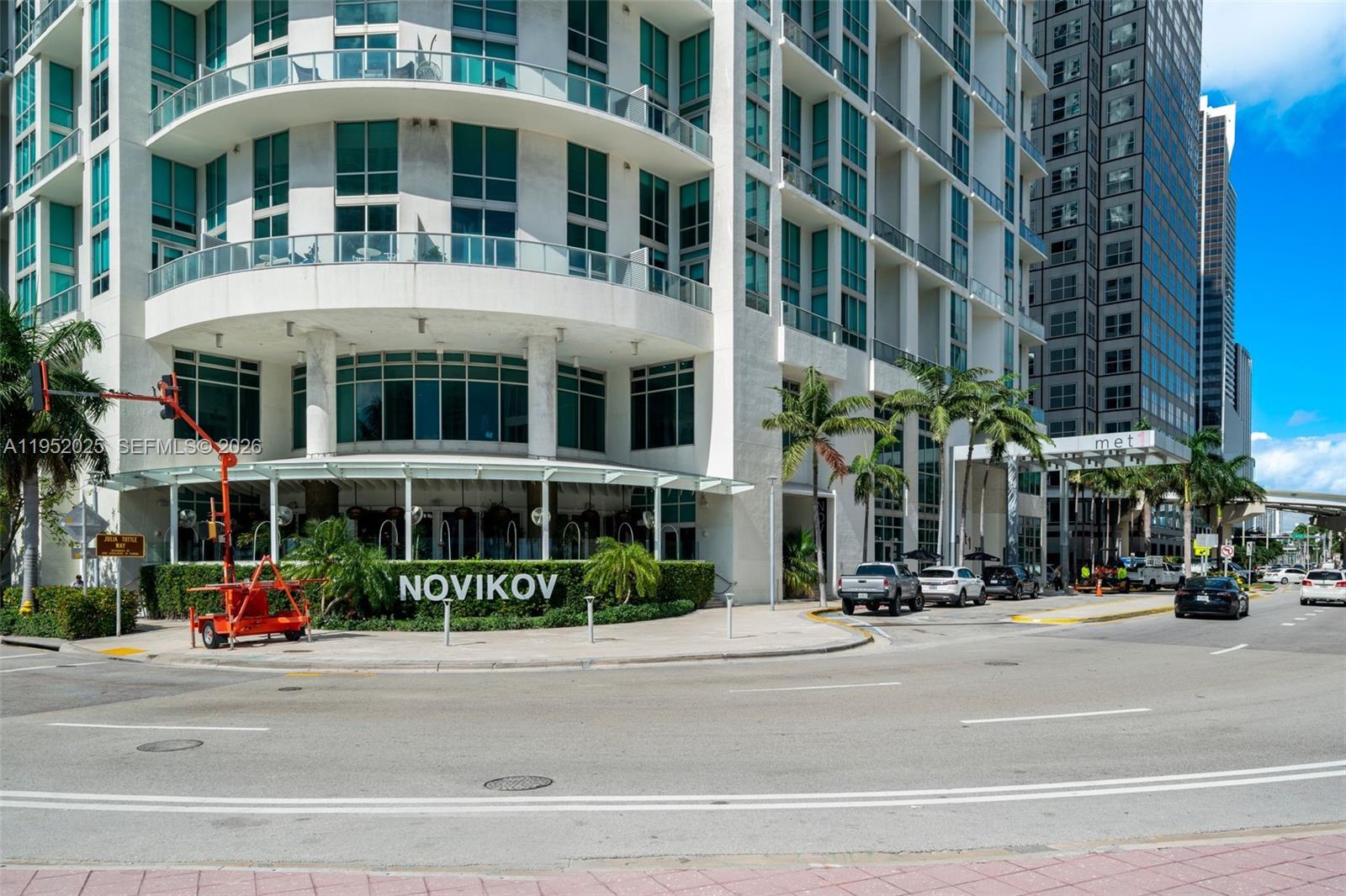 The exterior of a multi-story white building features a ground-level restaurant named Novikov — 300 S BISCAYNE BLVD # 410, Miami FL 33131, MIAMI, FL