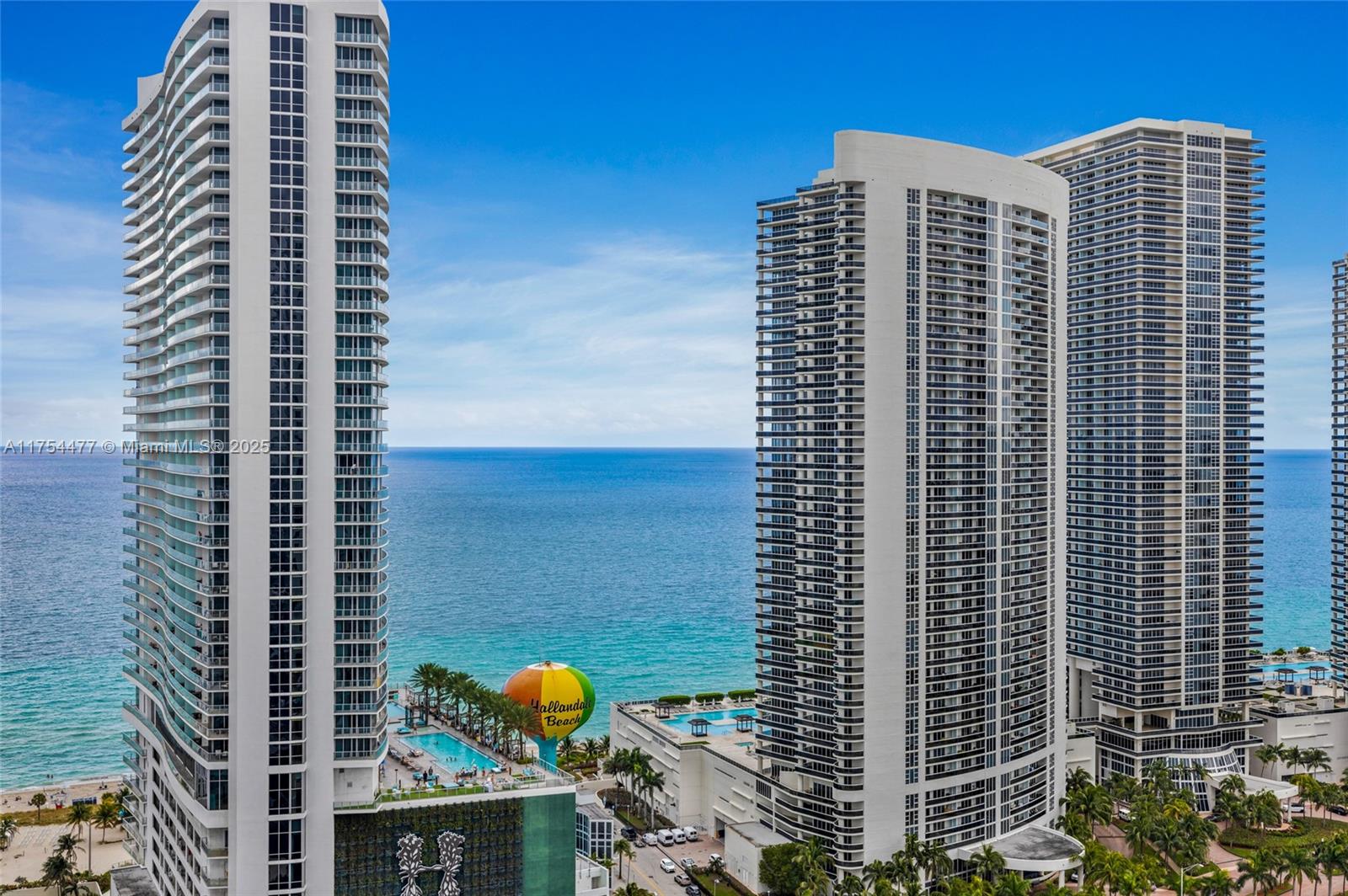 An elevated exterior view shows three tall residential towers overlooking the ocean and beach — 4010 S Ocean Dr # R2505, Hollywood FL 33019, HOLLYWOOD, FL