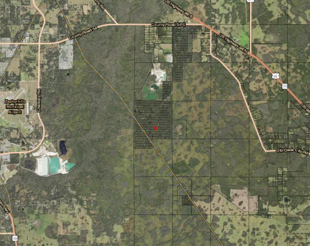 This map shows a red marker on a parcel of land near Zephyrhills Municipal Airport — 0 County Rd 54, FL 33849, FL