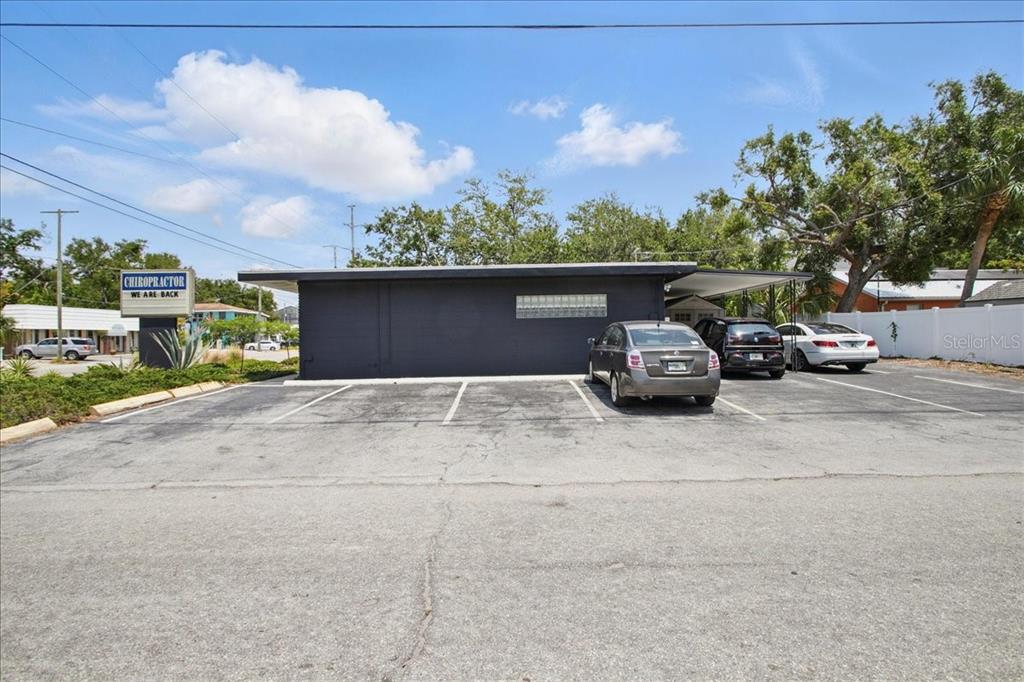 A dark gray commercial building features a parking lot and a chiropractor sign — 4250 W BAY TO BAY BOULEVARD, TAMPA, FL