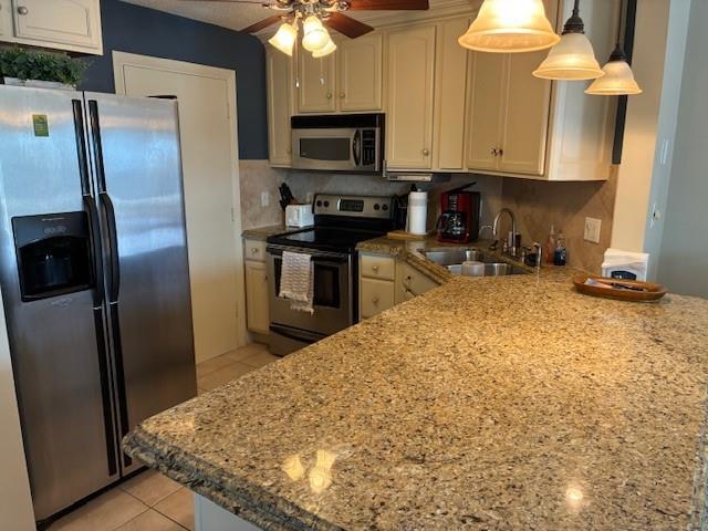 A kitchen features stainless steel appliances, granite countertops, and light-colored cabinetry — 133 N Pompano Beach Boulevard # 209, Pompano Beach FL 33062, POMPANO BEACH, FL