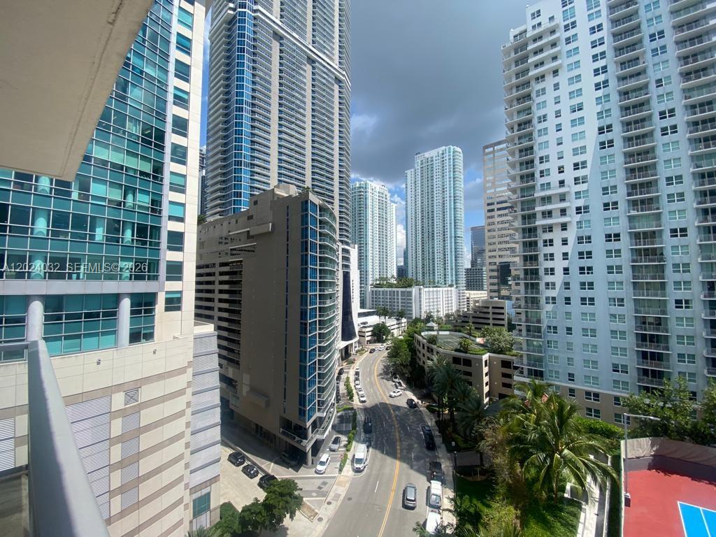 An elevated view of a city street surrounded by tall glass and concrete residential skyscrapers — 1155 Brickell Bay Dr # 1202, Miami FL 33131, MIAMI, FL