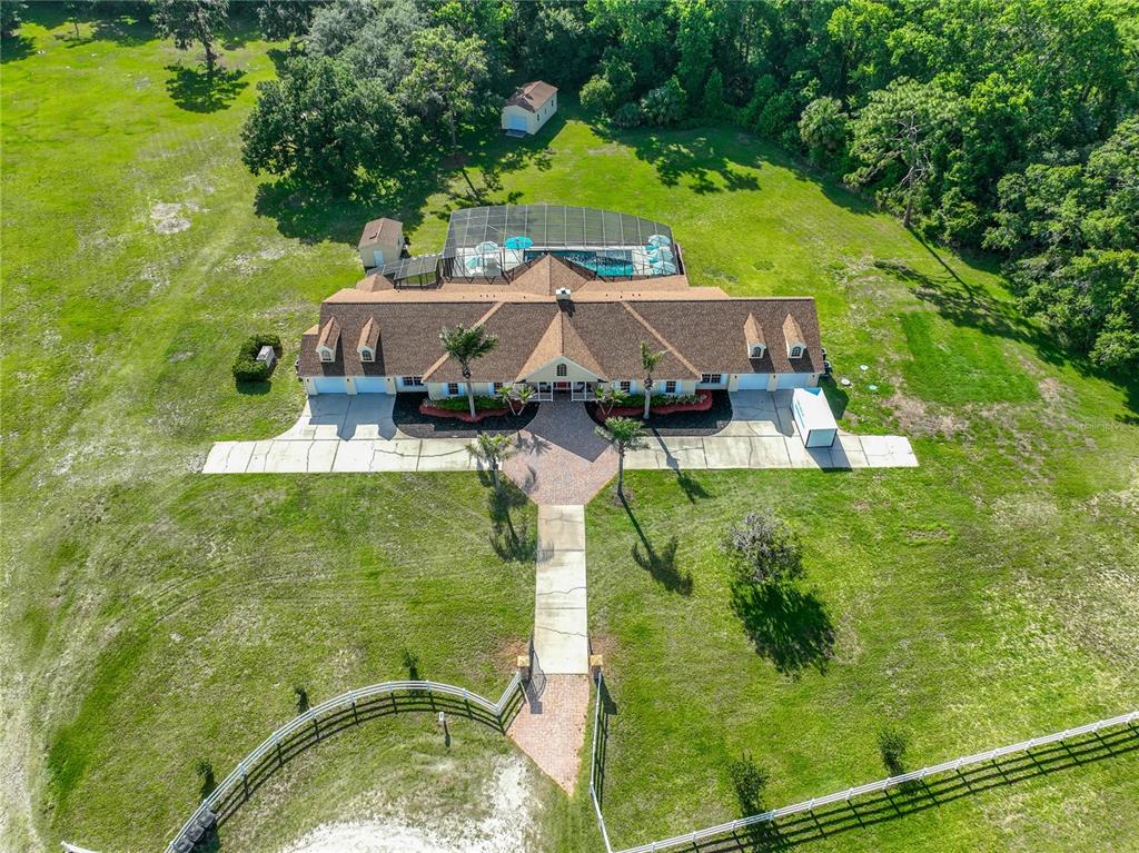 This is a floor plan of a large house with multiple bedrooms, garages, and a patio — 2300 PINE MEADOWS PLACE, CHULUOTA, FL