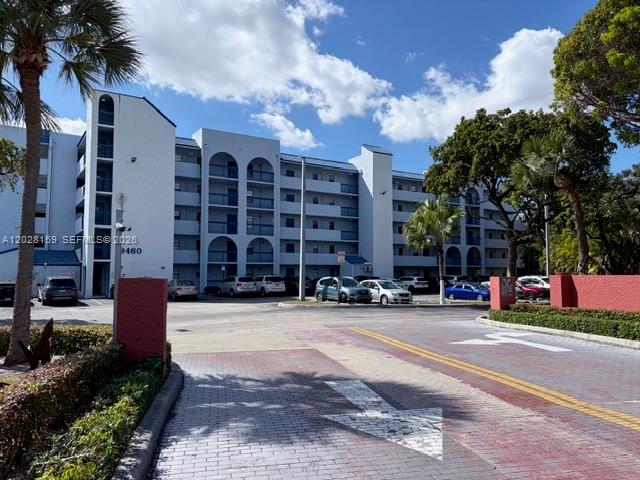 A multi-story apartment building features white facades, arched balconies, and a paved parking lot — 9460 Fontainebleau Blvd # 529, Miami FL 33172, MIAMI, FL