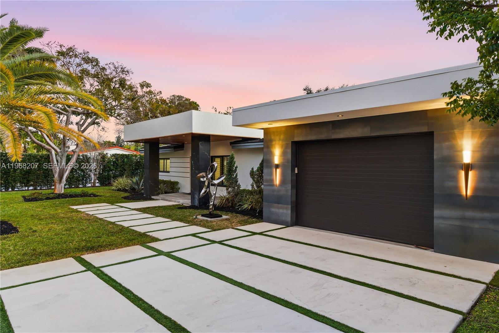 A modern house exterior features a flat roof, a garage, and a paved walkway — 400 NW 24th St, Wilton Manors FL 33311, WILTON MANORS, FL